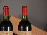 two bottles of wine sitting next to each other on a table