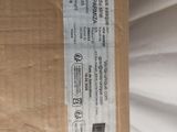 a box with a label on it sitting on top of a bed