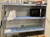 a shelf that has a bunch of bottles and containers on it
