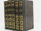a set of three black books with gold trimmings on them