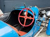 a blue car with a red steering and a red steering wheel
