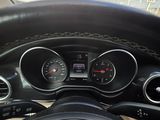 a steering wheel and dashboard of a car on the road