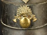 a metal container with a gold decoration on it