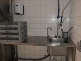 a kitchen with a sink and a refrigerator in it