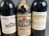 several bottles of wine are lined up on a table