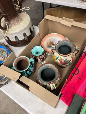 une boîte de vases posée sur une table, à côté d'autres objets