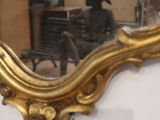 a mirror that is sitting on the wall in the room