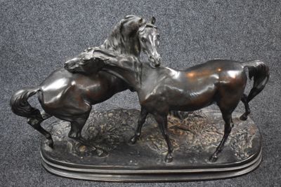 two horses that are standing next to each other
