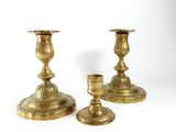 pair of antique brass candlesticks on a white background