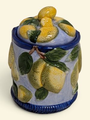 a blue and yellow jar with lemons on it