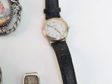 many different types of watches on a white table