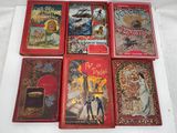 six children ' s books are lined up on a white surface