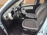 the interior of a small car with two seats and a steering wheel