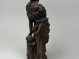 an image of a statue of a woman with a dog