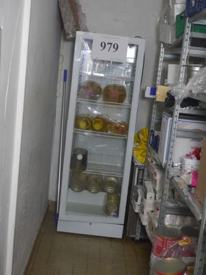 a small refrigerator in the corner of a room