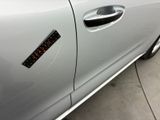 a close up of a car door with a sticker on it