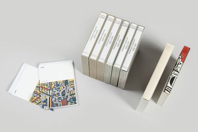 several books are stacked on top of each other on a table