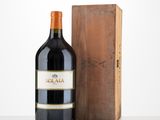 the bottle of wine is next to a wooden box