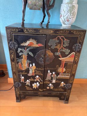 a black cabinet with a horse on top of it
