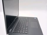 a laptop computer sitting on a white surface with a black keyboard
