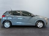 a grey car is parked in a room with a gray floor