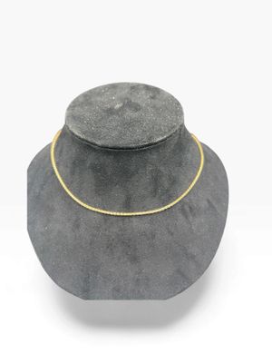 a close up of a necklace with a gold chain on it
