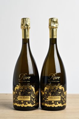 two bottles of wine sitting on top of a wooden table