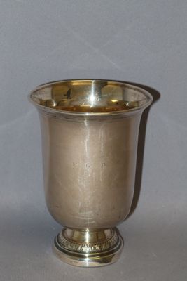 a silver cup that is sitting on a table