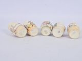 four different types of wine corks are lined up on a white surface
