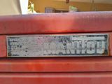a close up of a sign on the front of a red tractor