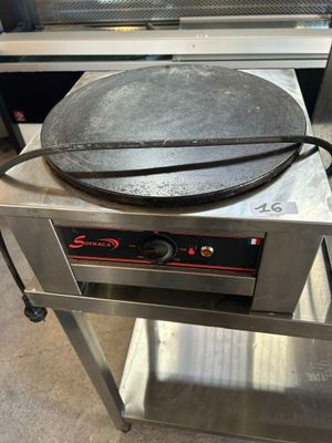 a pizza pan sitting on top of a table in a kitchen