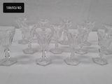 six clear glass wine glasses sitting on top of a white table