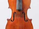 an old violin sitting on top of a white surface