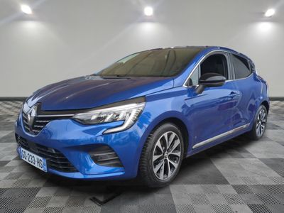 a blue car parked in a garage with a checkered floor