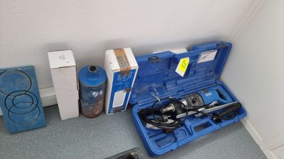 a blue case with tools in it sitting on the floor