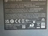 the back side of a laptop with a battery on top of it