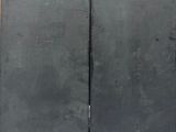 two black doors that are open on the side of a building