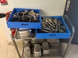 two trays of tools sitting on a metal cart