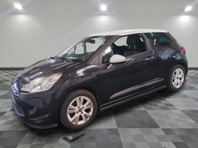 the small black car is parked on a checkered tile floor
