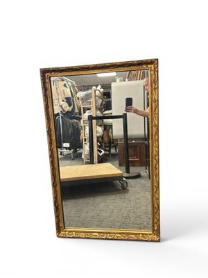 a mirror that is sitting on a table in a room