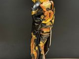an oriental figurine of a woman holding a fan on a table