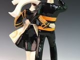 a figurine of a man and a woman dressed in uniform