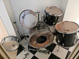 a black and white checkered floor with a drum set