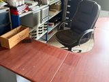 a desk with a chair and a computer on top of it