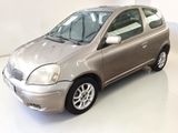 a silver car that is parked in a white room