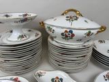 a lot of plates and bowls on the table