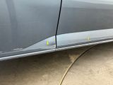 a car that has been painted gray with yellow dots on the side