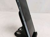 a cell phone that is on a stand on a table