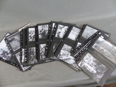 a lot of old black and white photos on a table