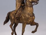 bronze statue of a man on a horse with a spear in his hand